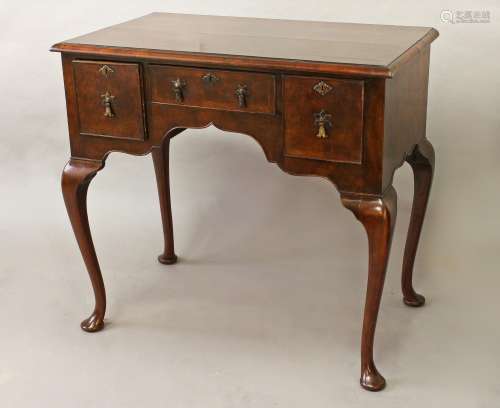 A QUEEN ANNE STYLE WALNUT LOWBOY, with a quarter veneered an...
