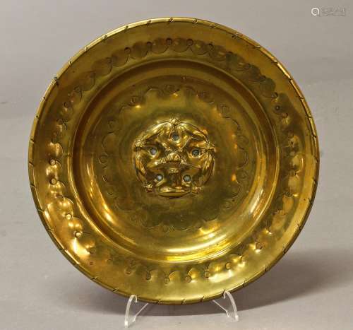 A 17TH CENTURY STYLE BRASS ALMS DISH, of circular dished for...