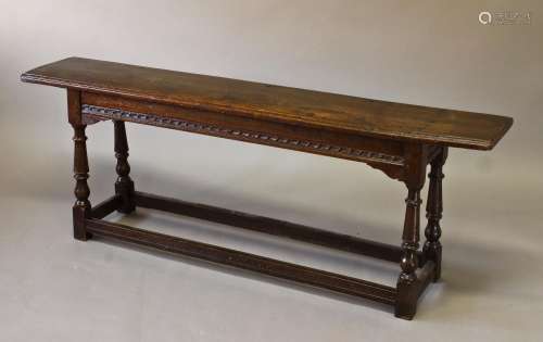 A 17TH CENTURY STYLE OAK LONG STOOL, with a long rectangular...