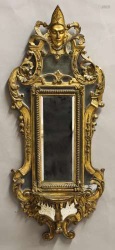 AN UNUSUAL GILTWOOD WALL MIRROR, with a central rectangular ...