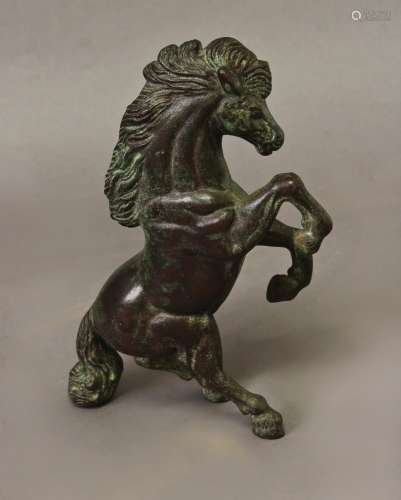 A CAST AND PATINATED BRONZE STUDY OF A REARING HORSE, the ho...