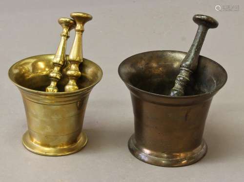 TWO SIMILAR BRONZE PESTLE AND MORTARS, both of traditional f...