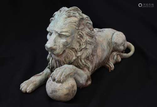 A SCULPTURAL BRONZE EFFECT HERALDIC LION, the lion recumbent...