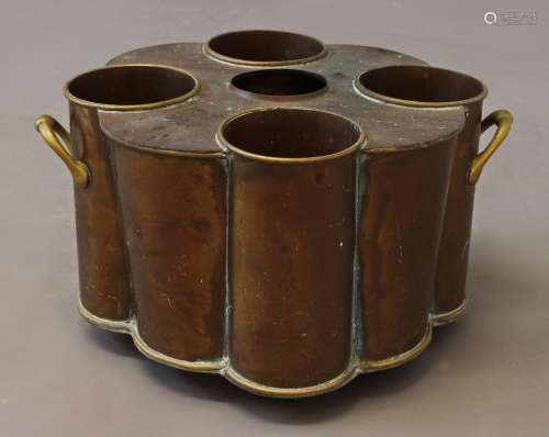 A BRASS AND COPPER WINE COOLER, with fittings for four bottl...