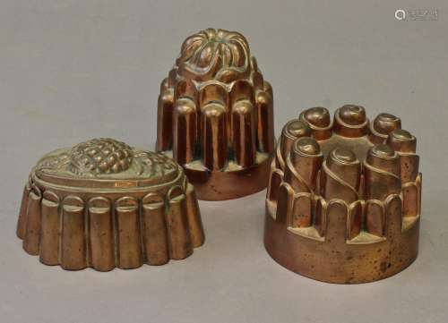 THREE VICTORIAN COPPER JELLY MOULDS, one with a pineapple mo...