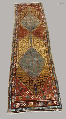 NORTH WEST PERSIAN RUNNER, circa 1920. The chestnut brown fi...