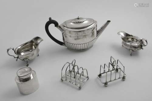 A MIXED LOT:- Two toast racks, a George II chased sauce boat...