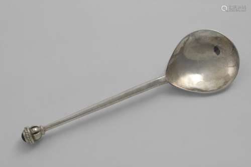 A CONTEMPORARY HANDMADE SPOON with a hammered finish and a k...