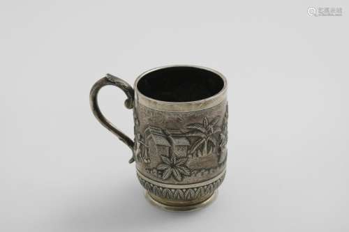 AN EARLY 20TH CENTURY INDIAN MUG with a leaf-capped scroll h...