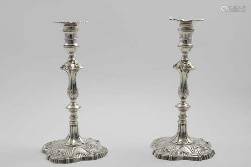 A PAIR OF EARLY GEORGE III CAST CANDLESTICKS on shaped squar...