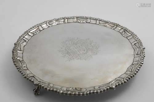 AN EARLY GEORGE III SALVER of shaped circular outline with a...