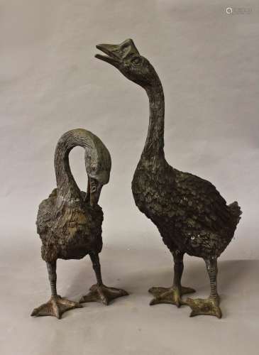 TWO BRONZE EFFECT SCULPTURAL GARDEN GEESE ORNAMENTS, one wit...