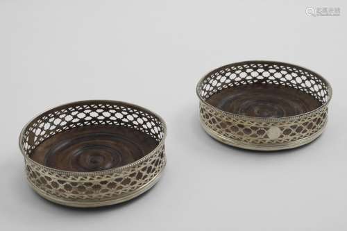 A PAIR OF GEORGE III WINE COASTERS with fret-pierced sides, ...