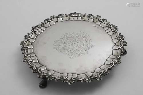 AN 18TH CENTURY SMALL CIRCULAR SALVER with a husk and scroll...