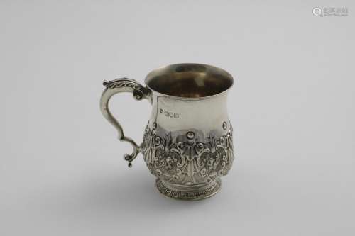 A LATE VICTORIAN BALUSTER MUG with embossed decoration aroun...