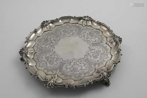 A VICTORIAN ENGRAVED SALVER of shaped circular outline with ...