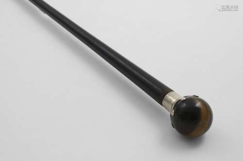 A LATE VICTORIAN BLACK-LACQUERED WALKING CANE with a mounted...