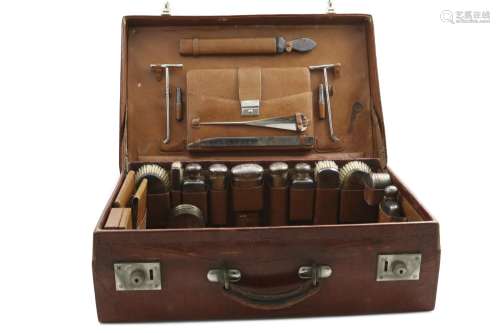 AN EARLY 20TH CENTURY CROCODILE LEATHER DRESSING CASE fitted...