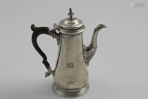 A LATE GEORGE II TAPERING COFFEE POT with a spreading circul...