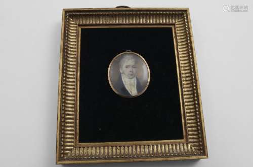 A GEORGE III MINIATURE PORTRAIT OF A GENTLEMAN in a navy blu...