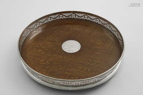 A VICTORIAN CIRCULAR MOUNTED OAK GALLERY TRAY on three bun f...