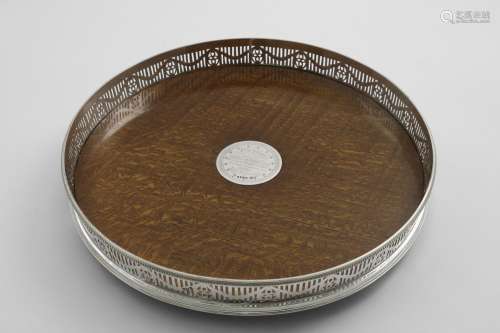 A VICTORIAN CIRCULAR MOUNTED OAK GALLERY TRAY on three bun f...