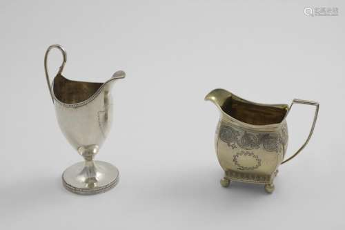 A GEORGE III ENGRAVED CREAM JUG on ball feet, gilt interior,...