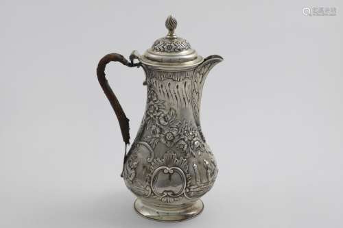 A GEORGE III BALUSTER HOT WATER JUG with repousse-work decor...