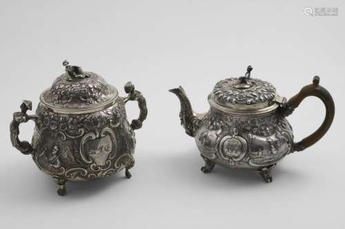A GEORGE III SMALL REPOUSSE-WORK TEA POT with chinoiserie de...