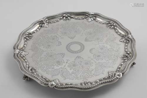 A VICTORIAN ENGRAVED SALVER of shaped circular outline with ...