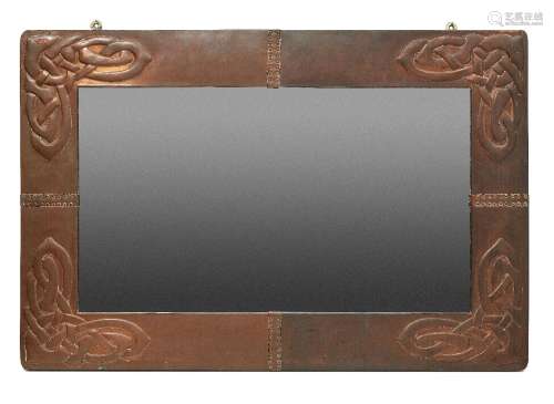 Archibald Knox (British 1864-1933), a copper wall mirror for...