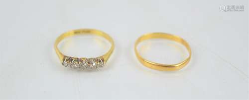 A 22ct gold wedding ring together with an 18ct gold ring set...