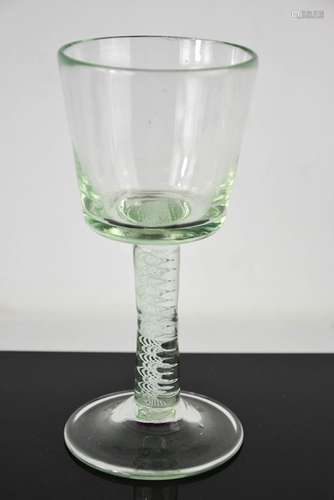 A Georgian glass with twist decorated stem, raised pontil to...