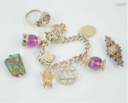 A sterling silver charm bracelet with various charms togethe...