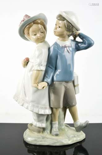 A Lladro porcelain figure group titled Puppy Love; boy and g...