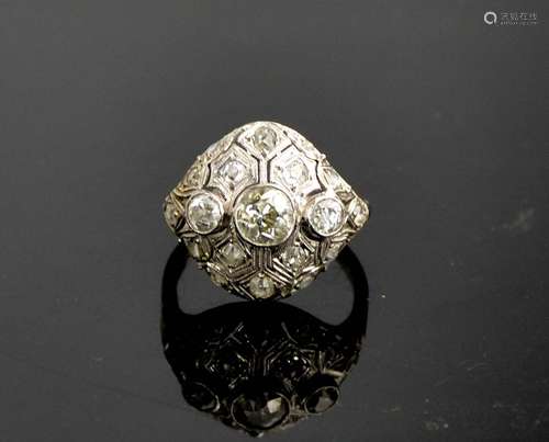 An Art Deco diamond and platinum ring, the central diamond a...