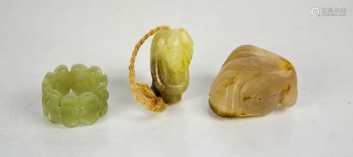 Three Chinese jade carvings, a ring, pendant/bead, and carve...