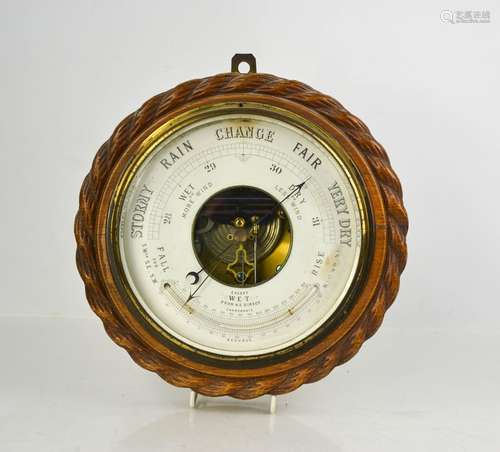 An oak framed wall barometer, of circular form, circa 1940, ...