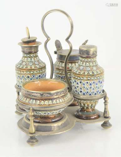 A Doulton Lambeth four piece cruet set in a silver plated st...