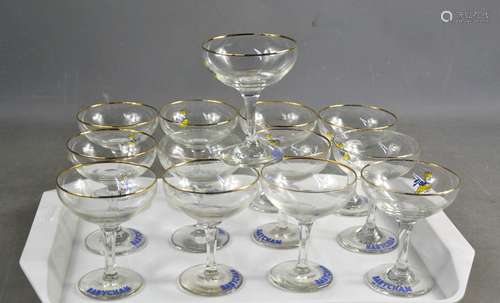 A set of thirteen Babycham glasses.