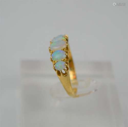 An 18ct gold ring set with five graduated oval cabochon opal...