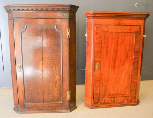 A 19th century oak corner cupboard with shell motif to front...