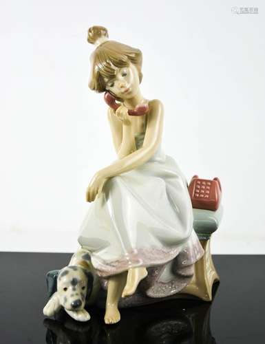 A Lladro porcelain figurine titled Chit Chat, girl on the ph...