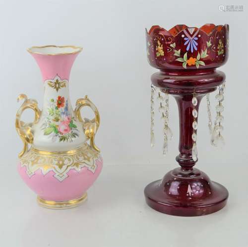 A red lustre glass vase decorated with flowers together with...