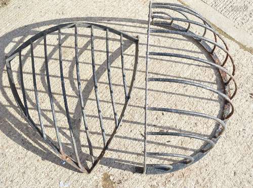 Two antique iron hay racks