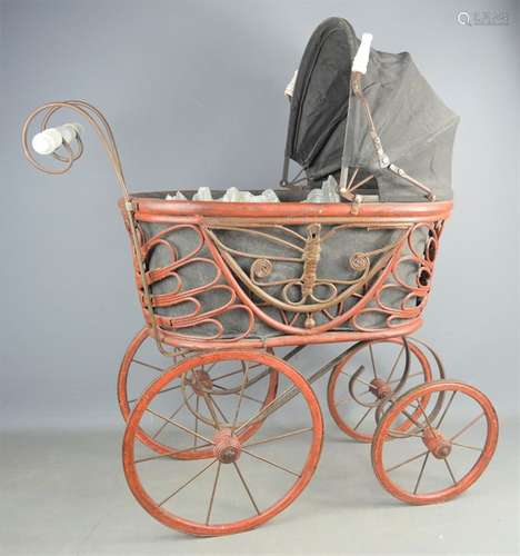 A wicker child's pram fitted with hood, liner and porcelain ...