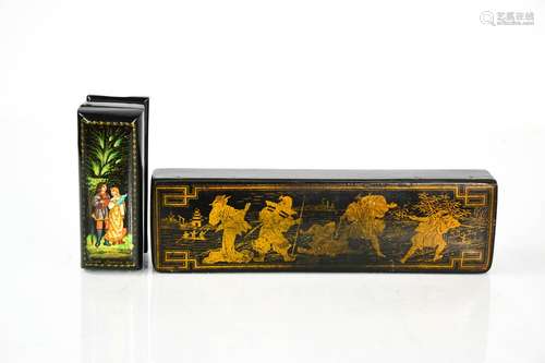 A Chinese black laquered papier mache box gilded to depict a...