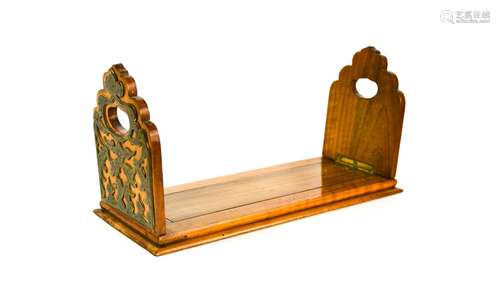 A mahogany and brass book slide, with shaped ends boards, th...