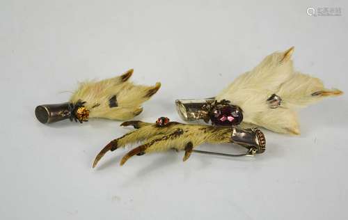 Three Scottish grouse foot brooches, one with silver mount, ...