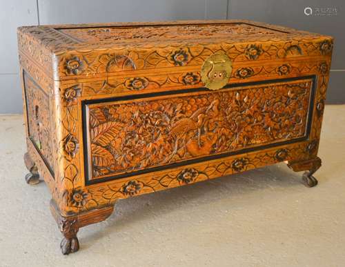 A Chinese carved blanket box, landscape and Crane carving to...